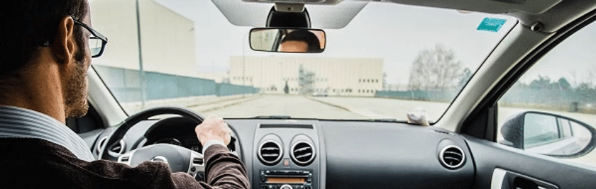 man driving while wearing glasses