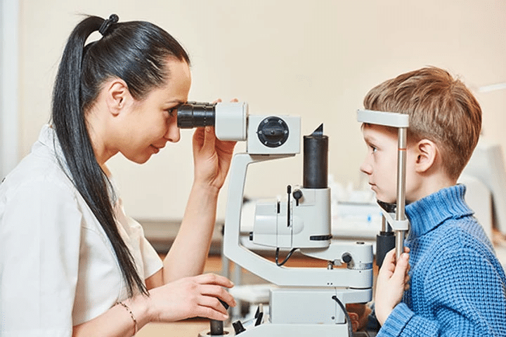 Kid having his eyes tested for eye health conditions