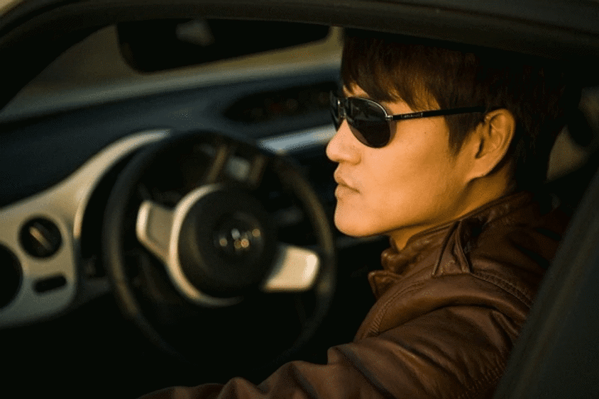 Woman wearing glasses while driving her car