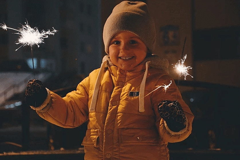 kid holding fireworks