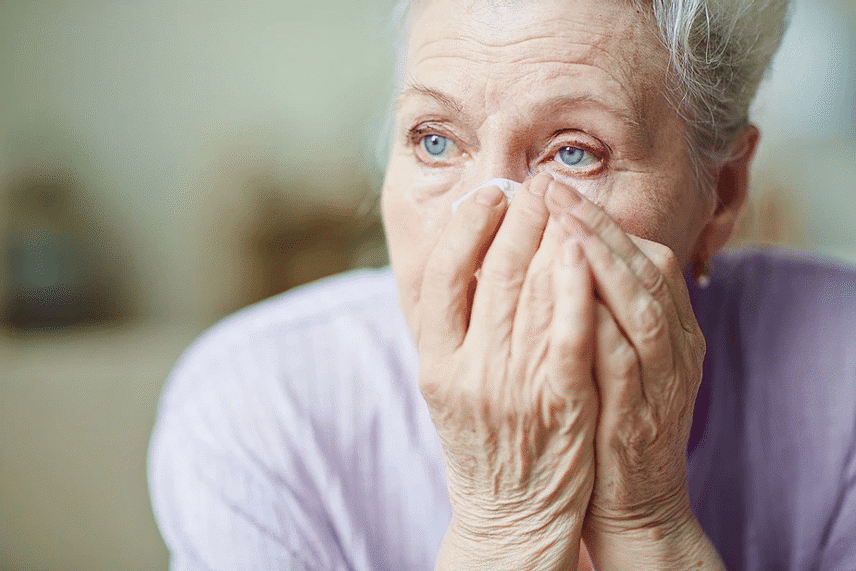 old woman suffering from a blocked tear duct