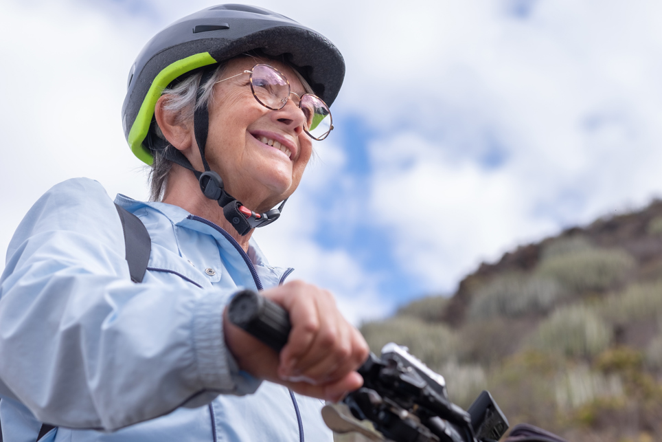elderly woman wearing light varifocal lenses and going cycling