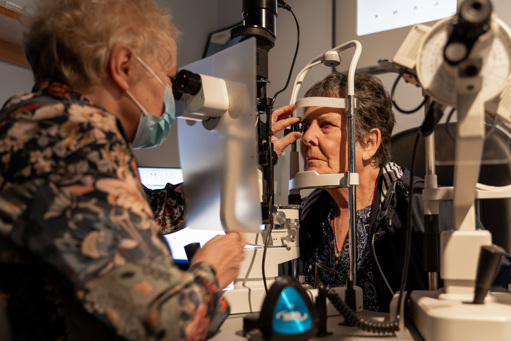 Optometrist testing patients eyes