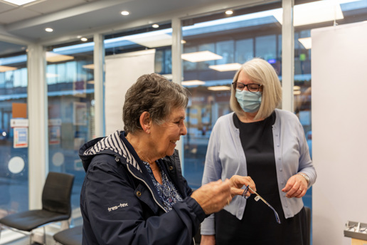 Dispensing Optician helping choose glasses