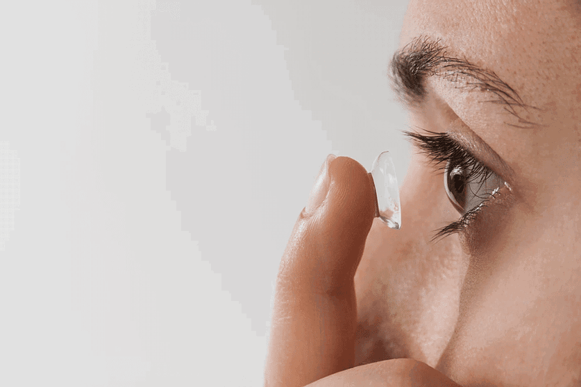 woman applying ortho k lenses;