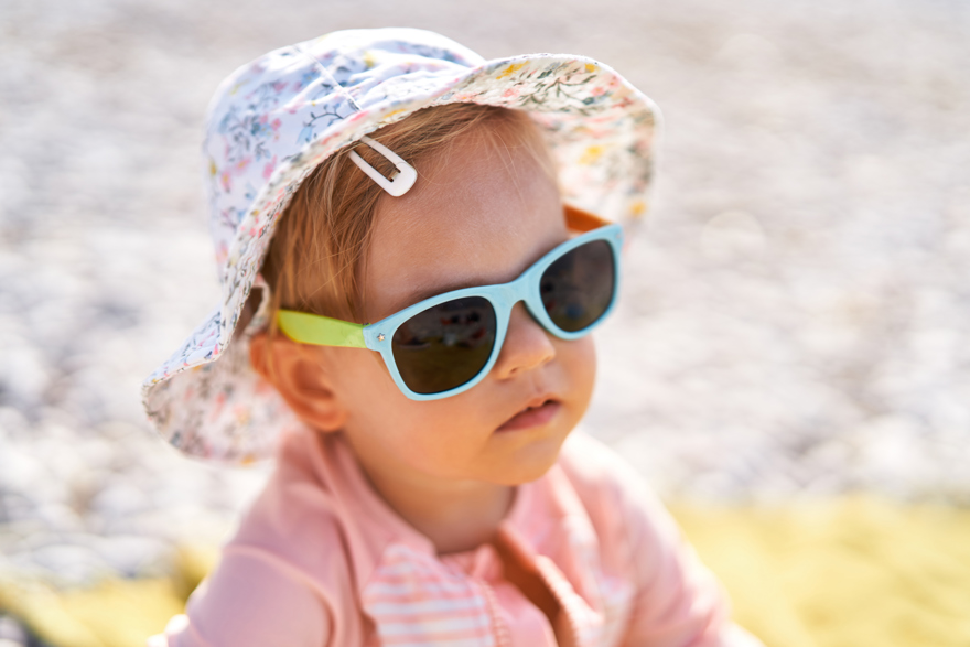 Little Girl In Sunglasses At The Beach