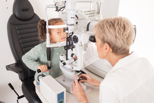 girl having her eyes tested by an local optician